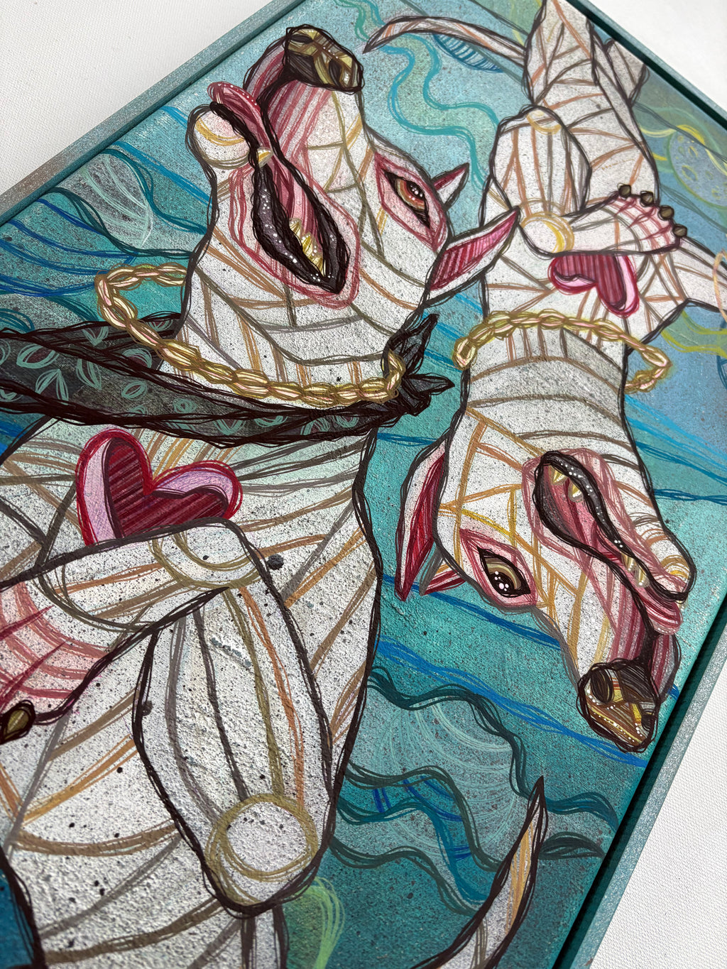 Stained glass artwork of two white dogs with a blue and green background