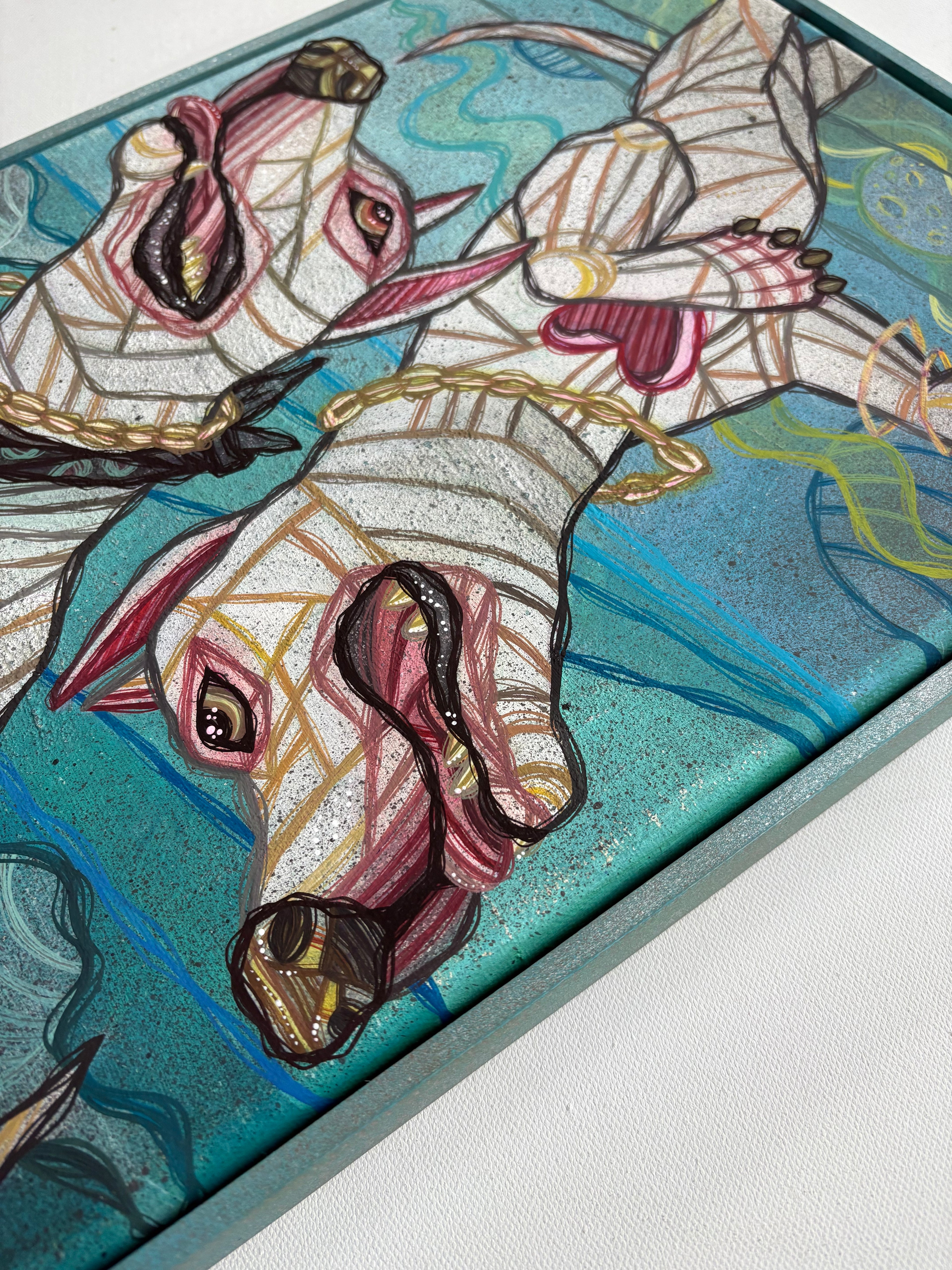 Colorful mosaic geometric artwork of two dogs in space on a rectangular framed canvas

