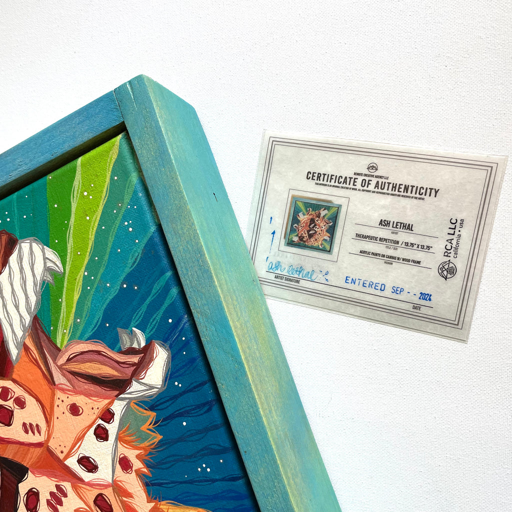 Framed artwork with a certificate of authenticity on a white background