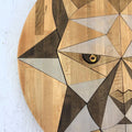Wooden wall art in the shape of a geometric big cat cougar mountain lion face on a white background