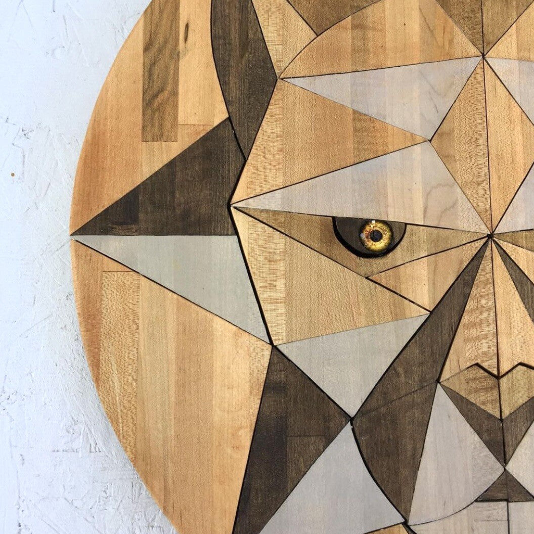 Wooden wall art in the shape of a geometric big cat cougar mountain lion face on a white background