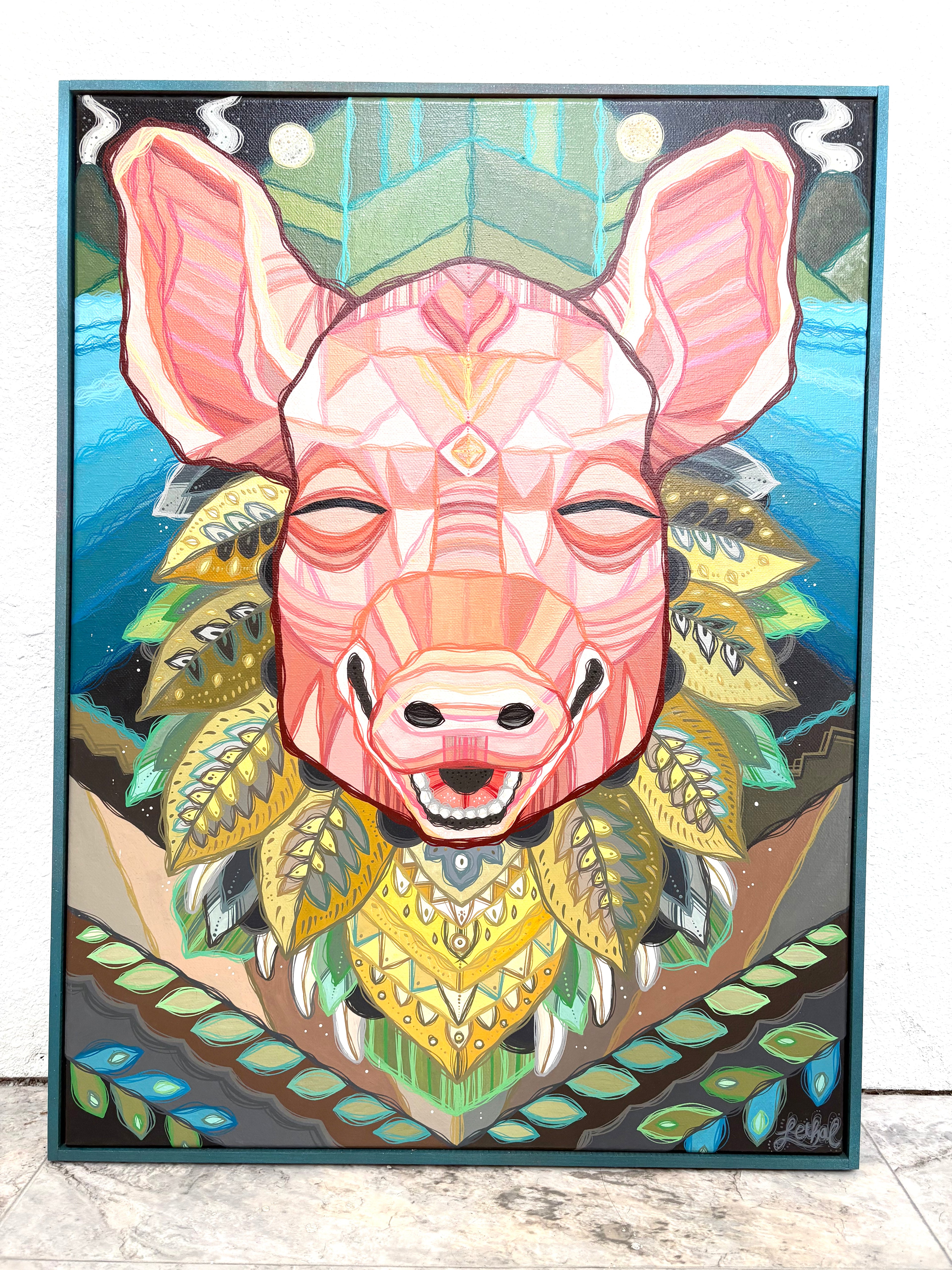 Colorful geometric pig art piece on a framed canvas