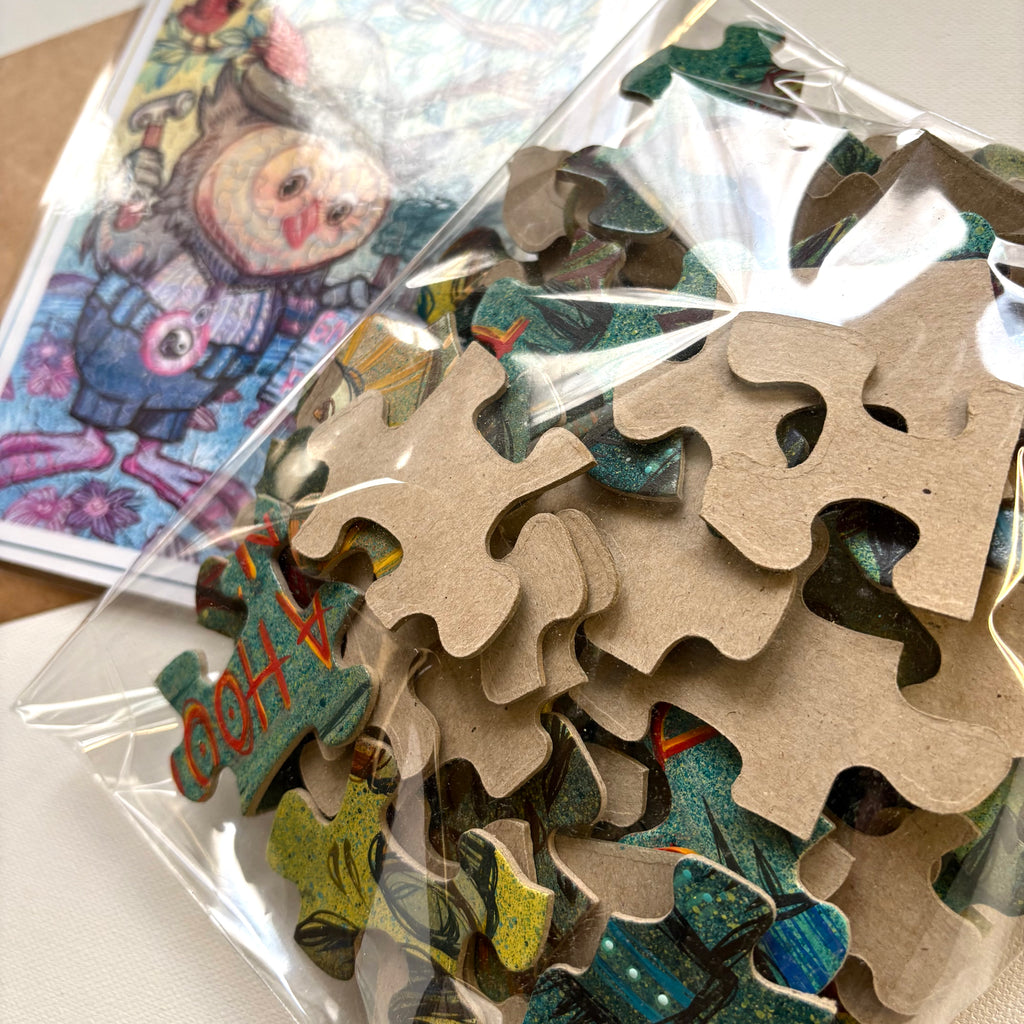 Pile of puzzle pieces with colorful illustrations in a clear plastic bag.