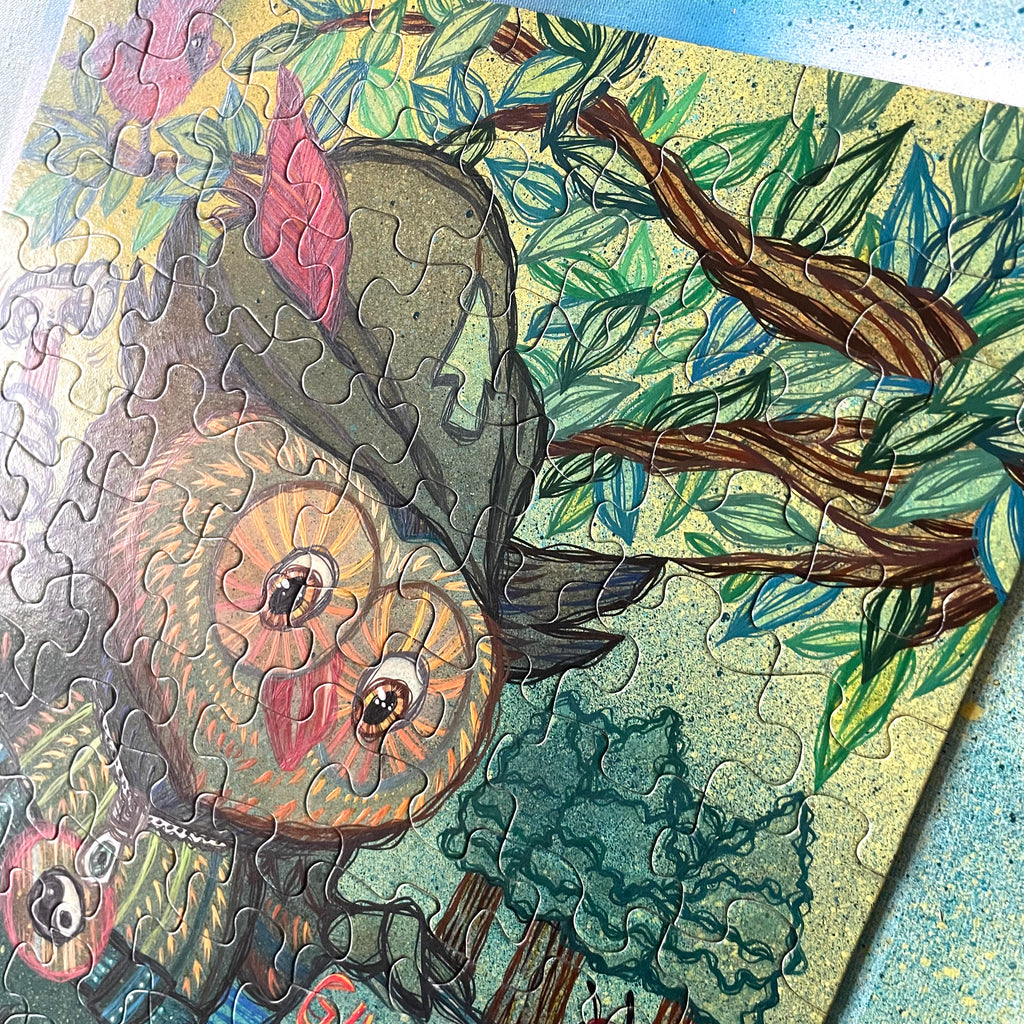 Jigsaw puzzle with a completed section of a owl-like creature among leaves
