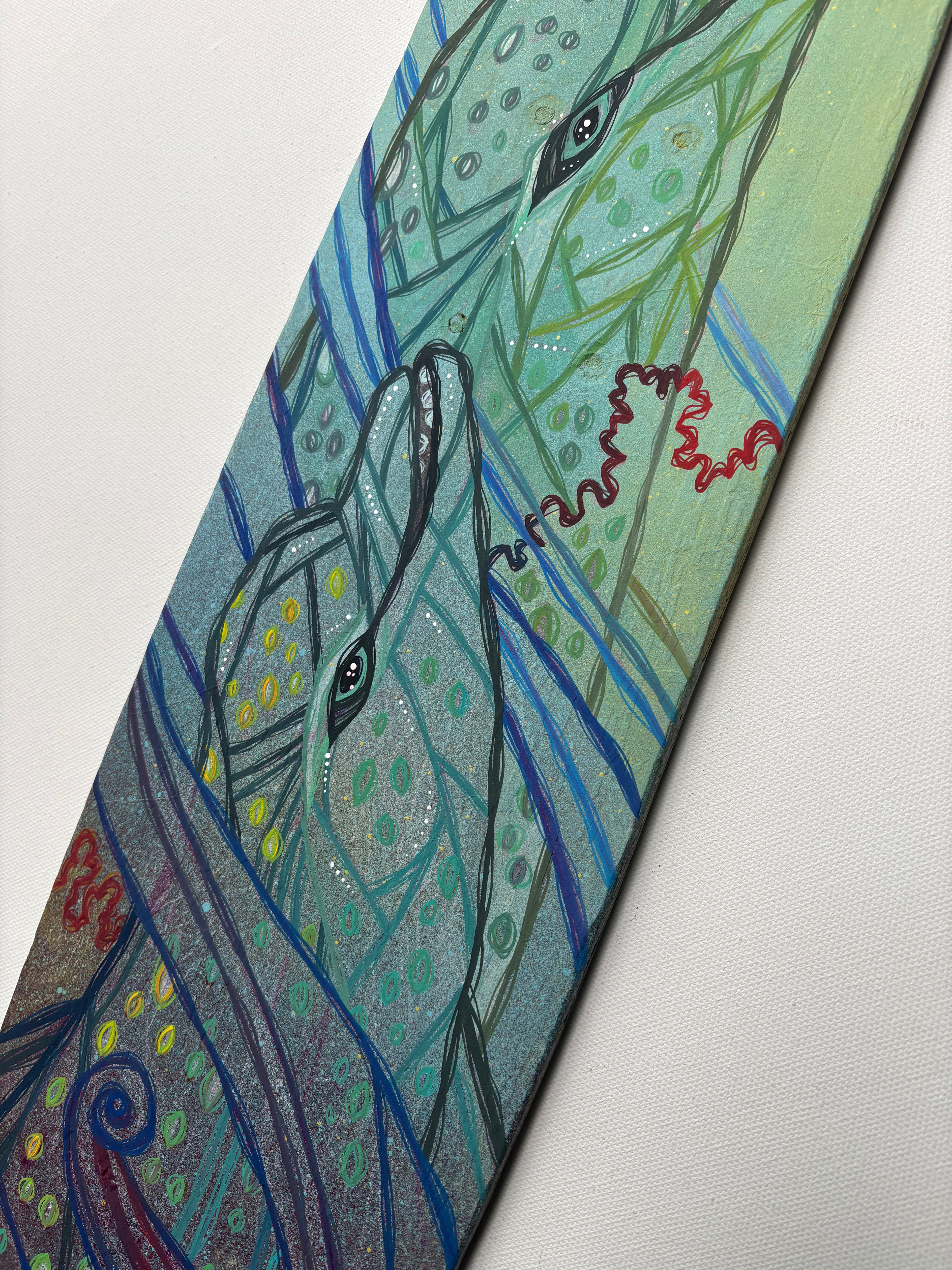 Colorful abstract painting of two intertwined dolphins on a white background