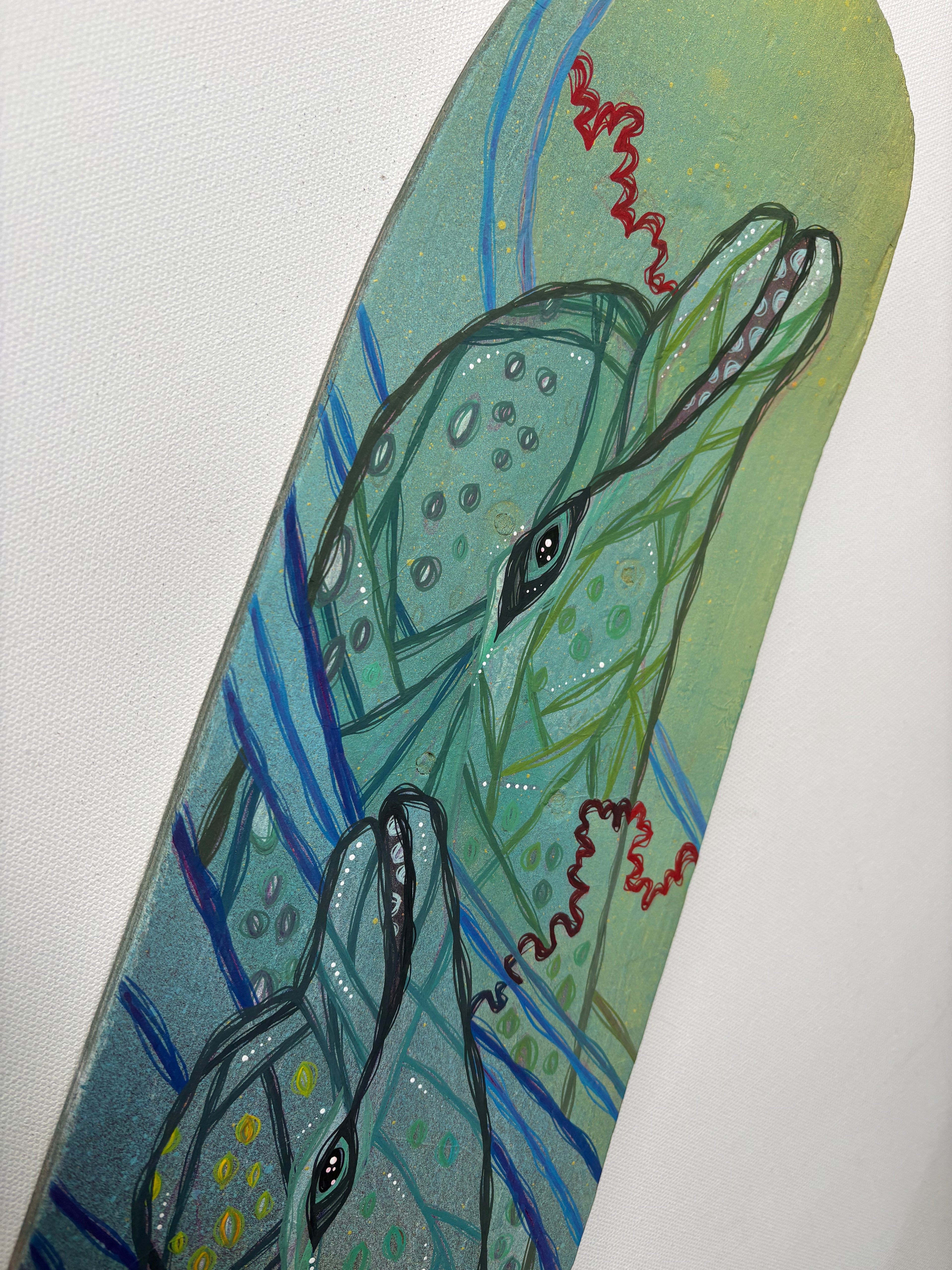 Decorative skateboard with a stylized dolphin design on a light green background