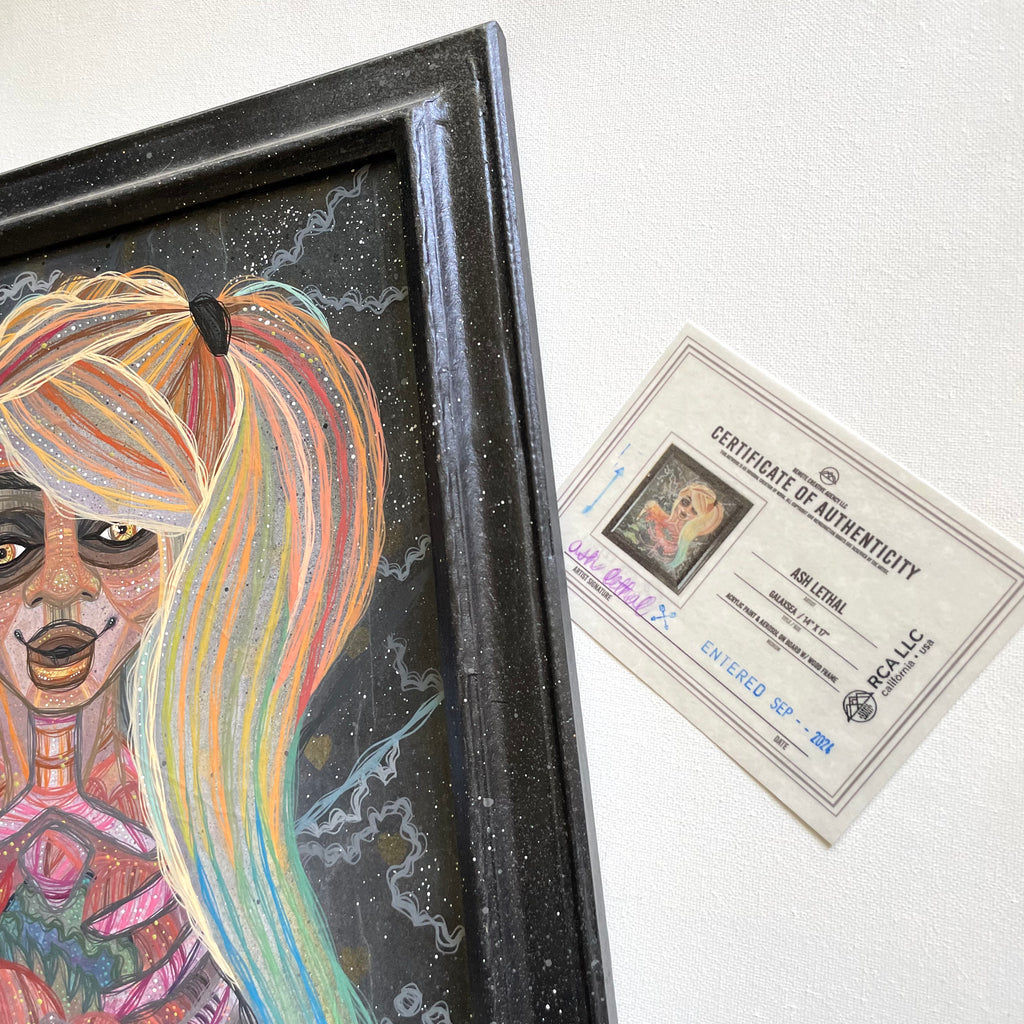 Framed artwork with a colorful figure and a certificate of authenticity on a white background