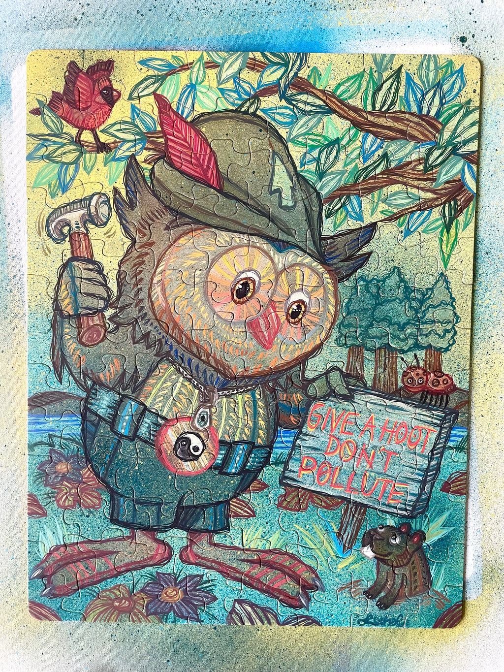 Illustrated Puzzle of an owl character holding a sign with environmental message, surrounded by nature elements.