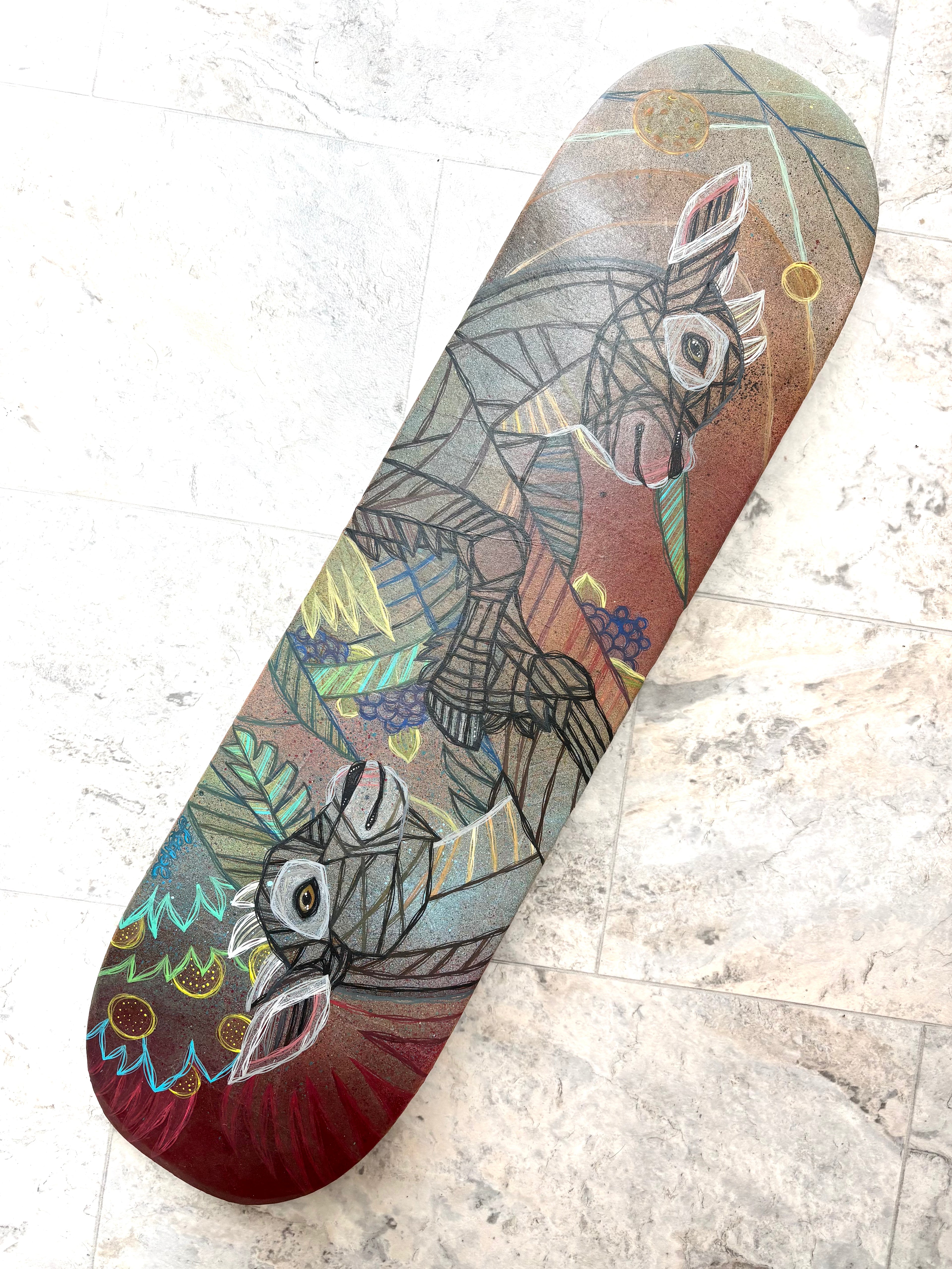 Skateboard deck with geometric goats animal design on a textured surface