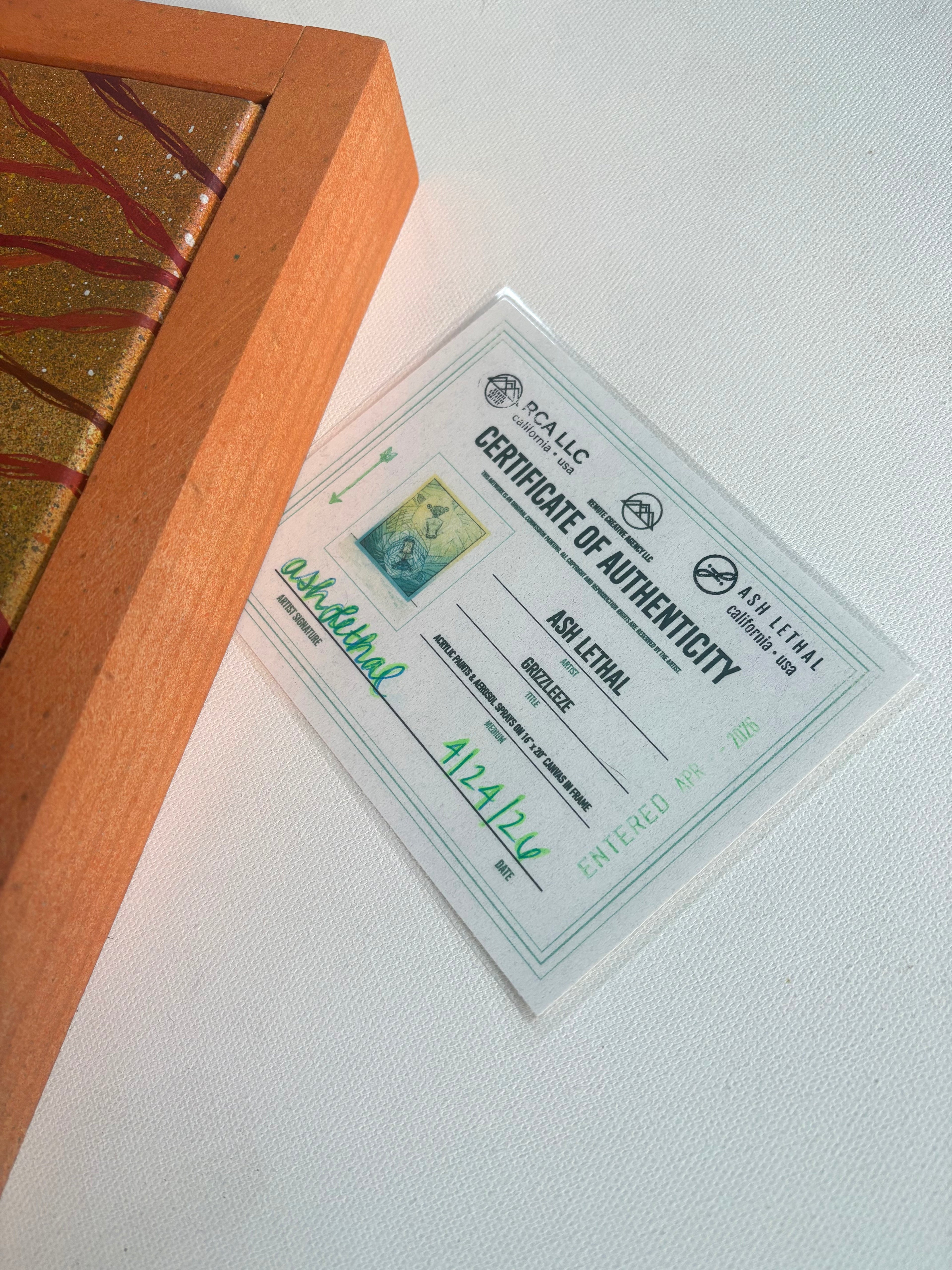 Certificate of Authenticity for a piece of art with a wooden frame.