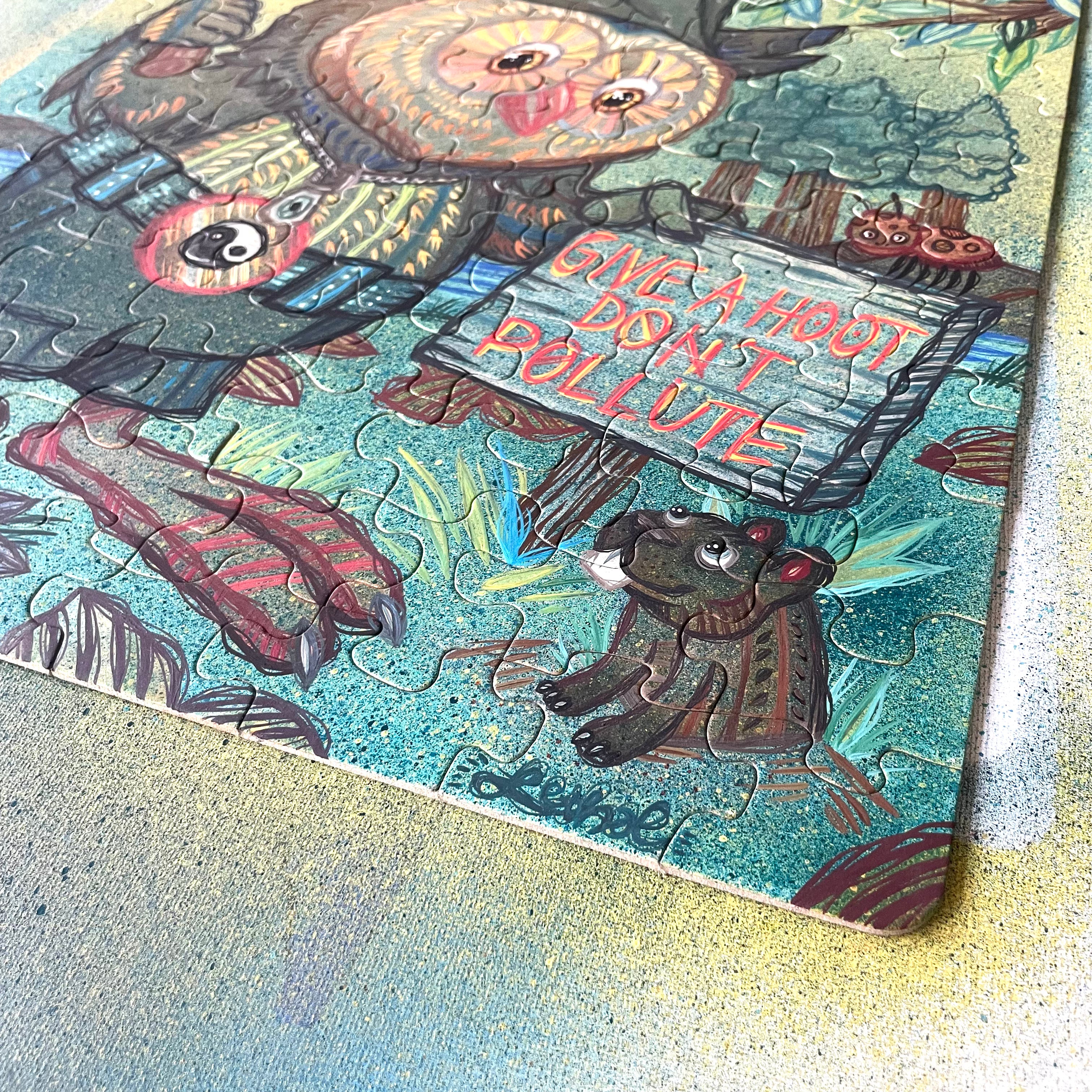 Colorful illustration with animals and a sign saying 'Give a Hoot, Don't Pollute' on a textured surface.