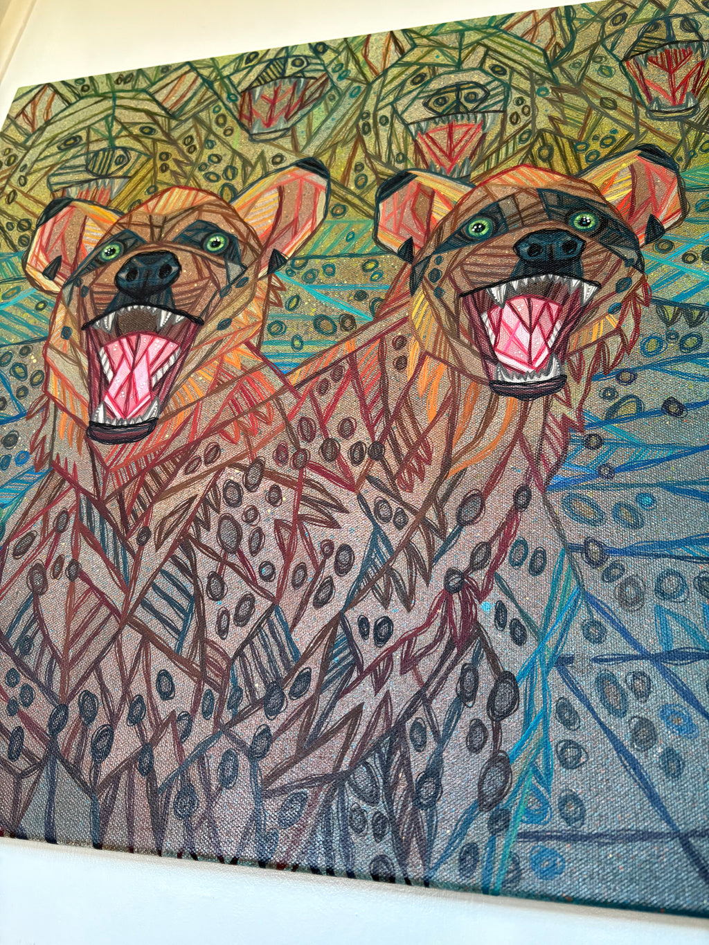 Colorful wildlife artwork of two hyena wild dogs with a patterned background by ash lethal