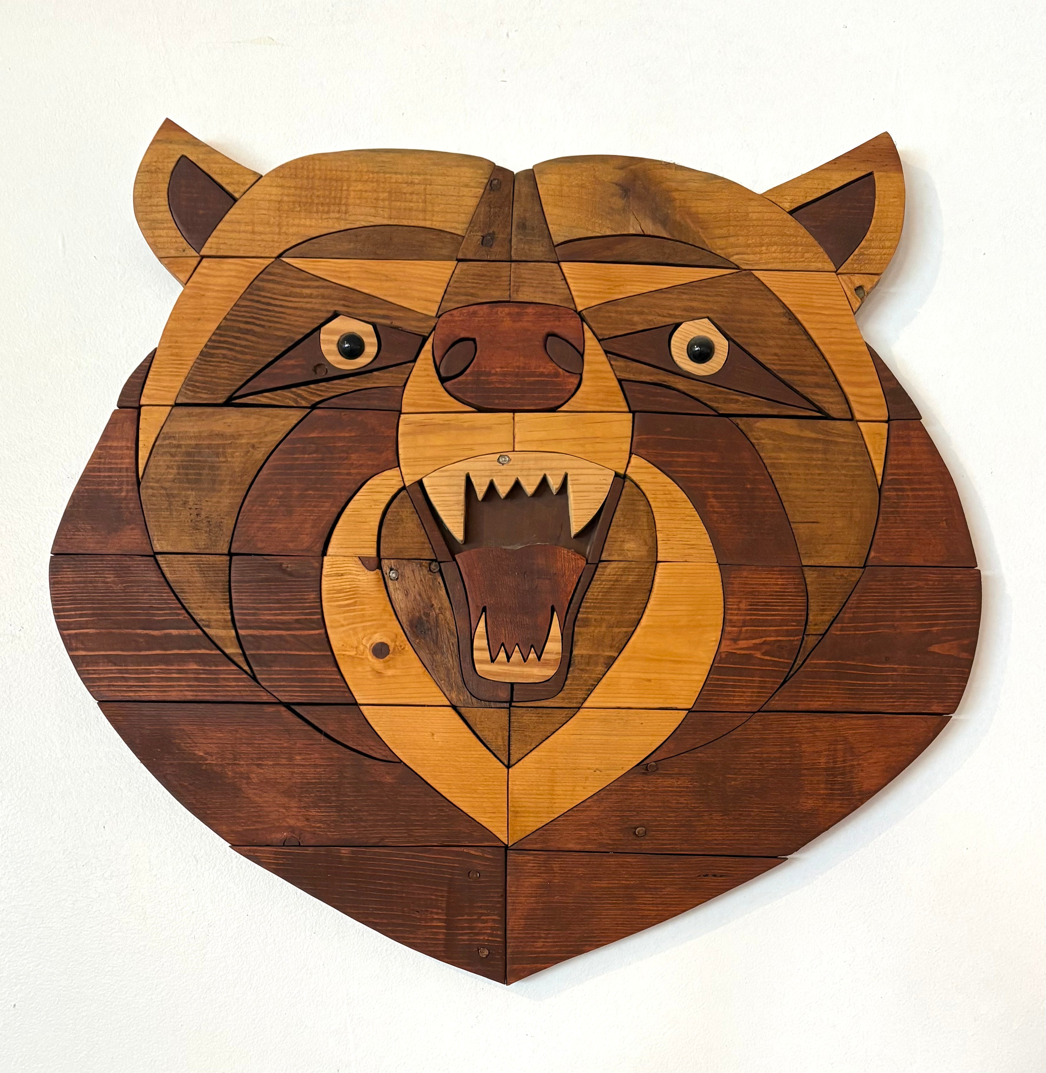 Wooden bear head wall art on a white background