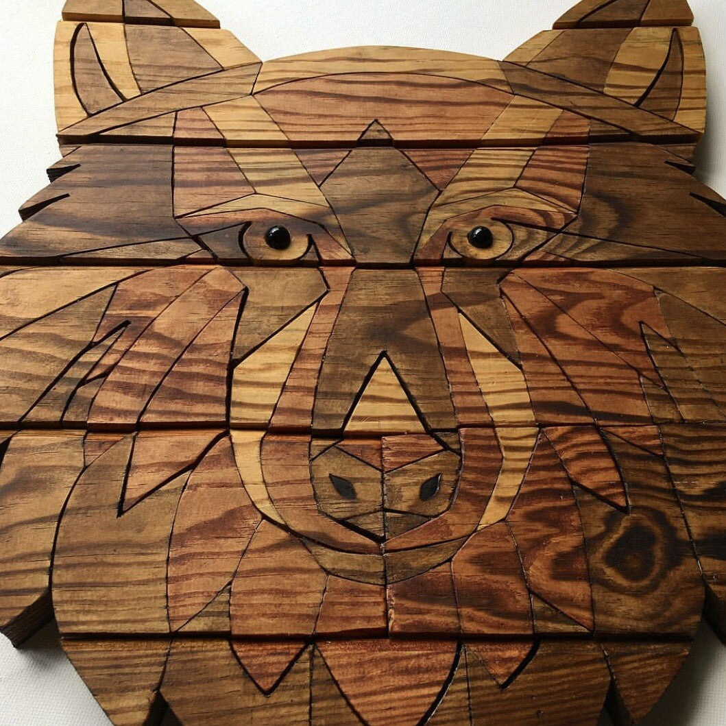 Wooden puzzle in the shape of a wolf face on a white background