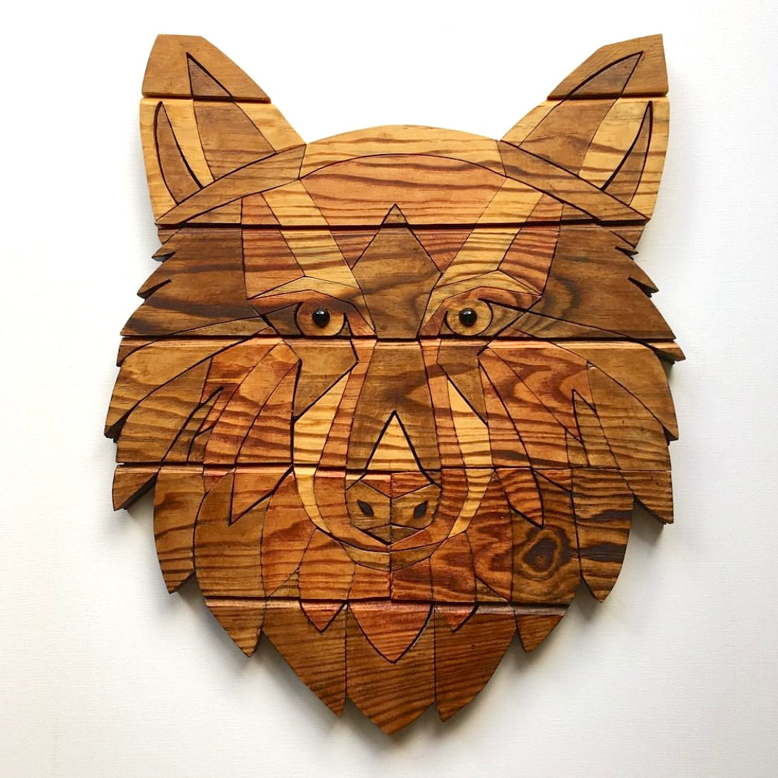 Wooden wolf head wall art on a white background