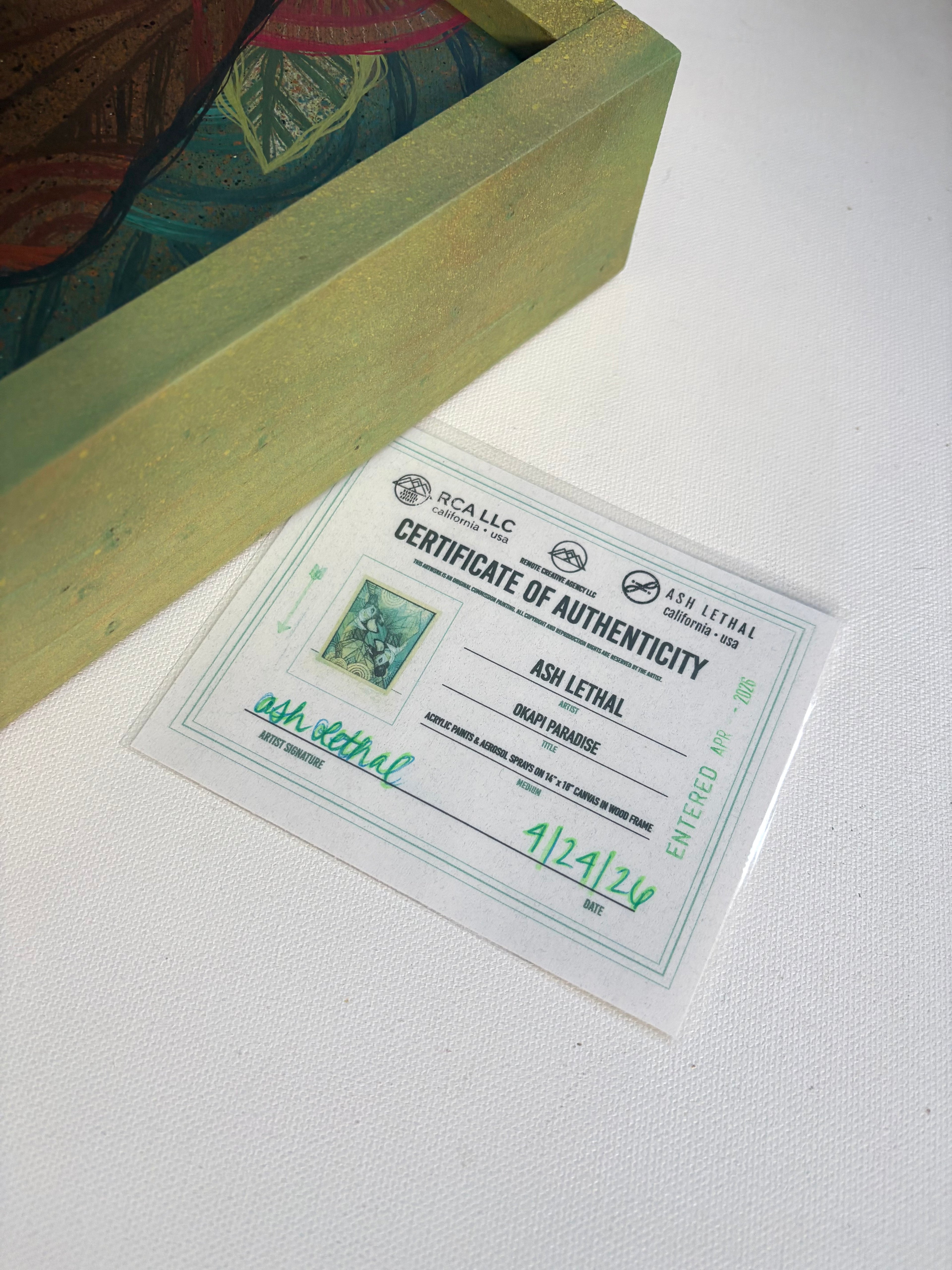 Certificate of Authenticity on a white surface with a green box in the background