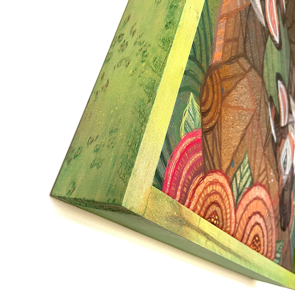 Close-up of a colorful mosaic painting in a custom wood frame stained lime green
