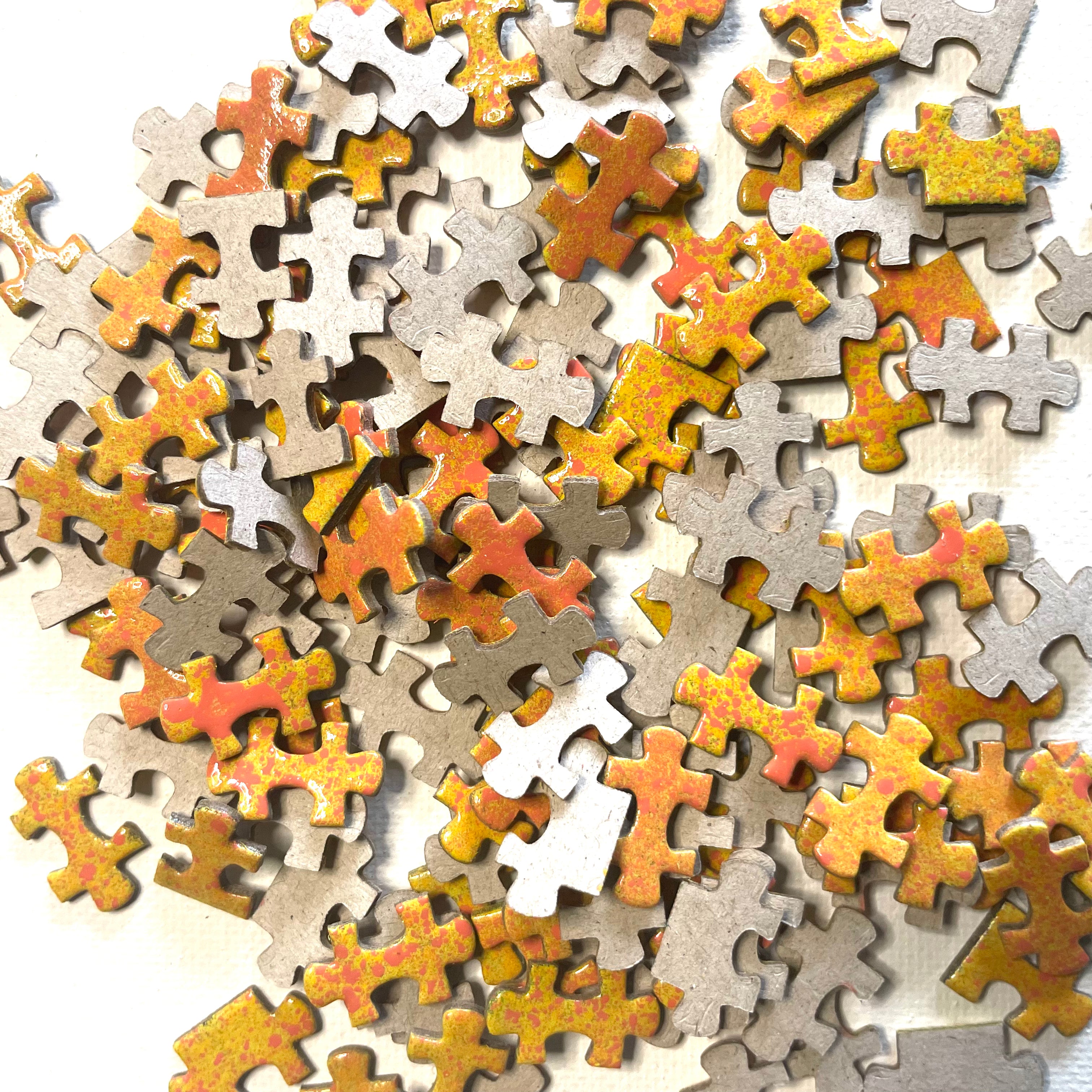 Assorted puzzle pieces in various colors on a white background