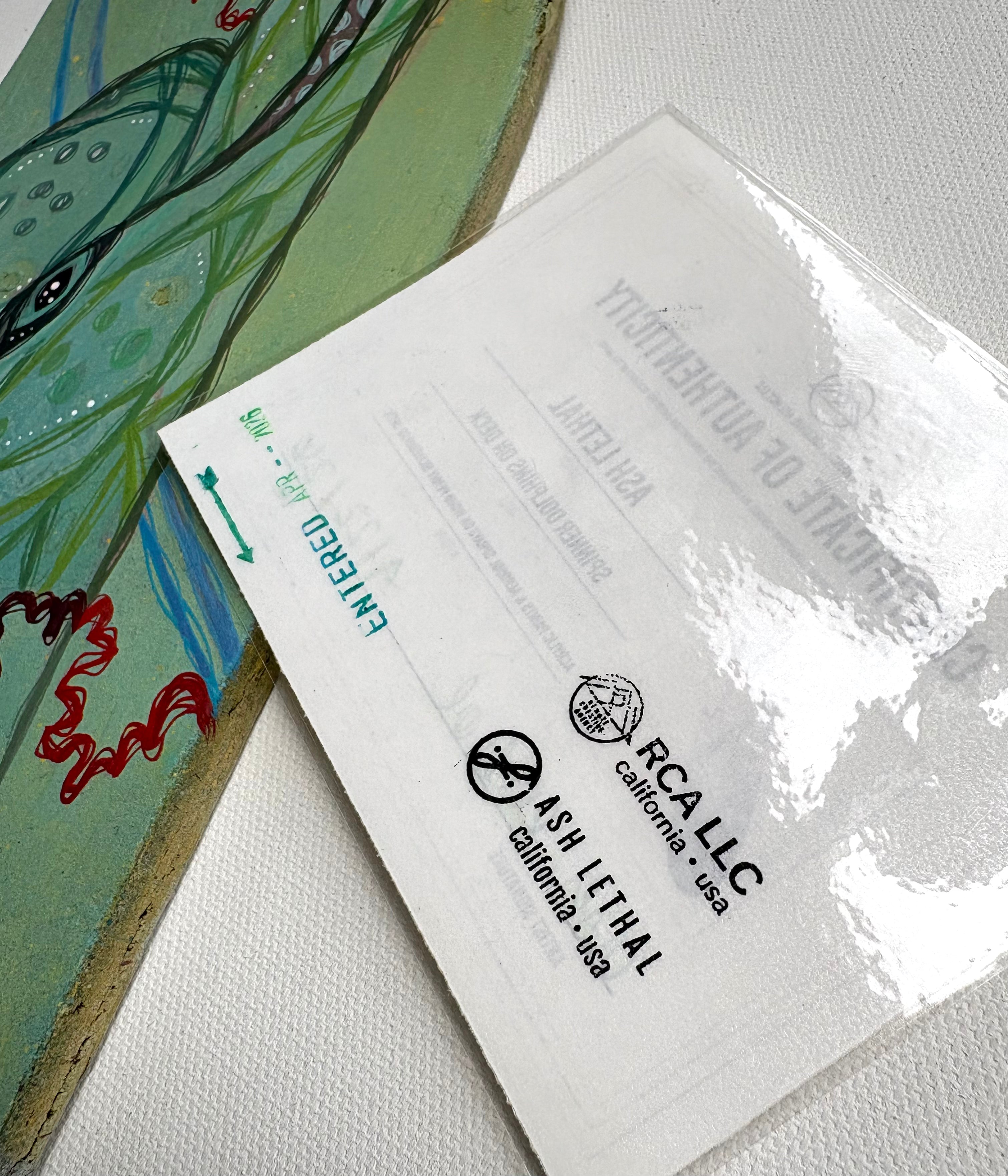 COA Card with RCA LLC and Ash Lethal branding on a textured surface