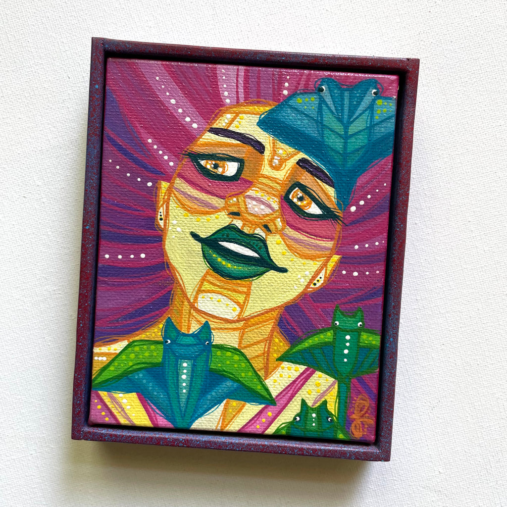Colorful framed artwork of a stylized face with abstract patterns on a white background
