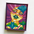 Colorful framed artwork of a stylized face with abstract patterns on a white background