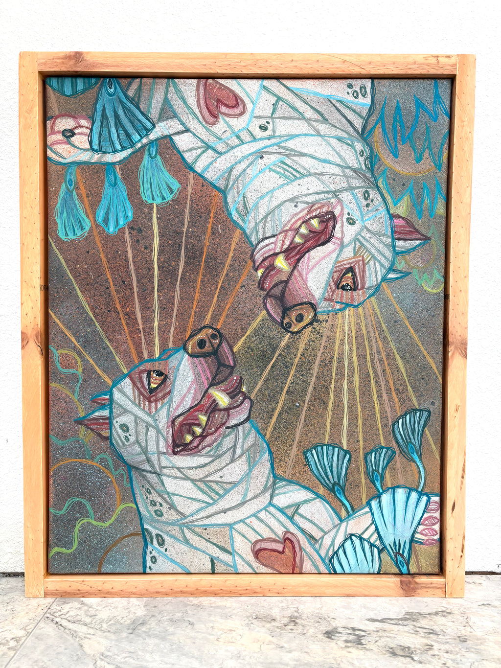 Colorful abstract artwork with dog-like creatures in a wooden frame.