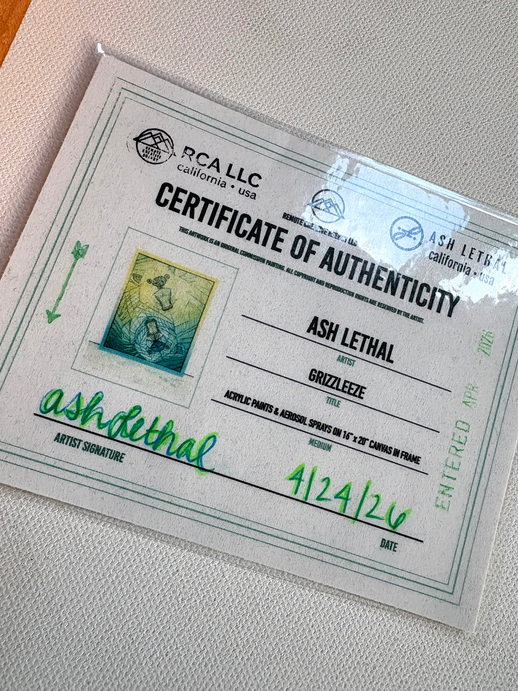 Certificate of Authenticity for an artwork by Ash Lethal on a textured surface