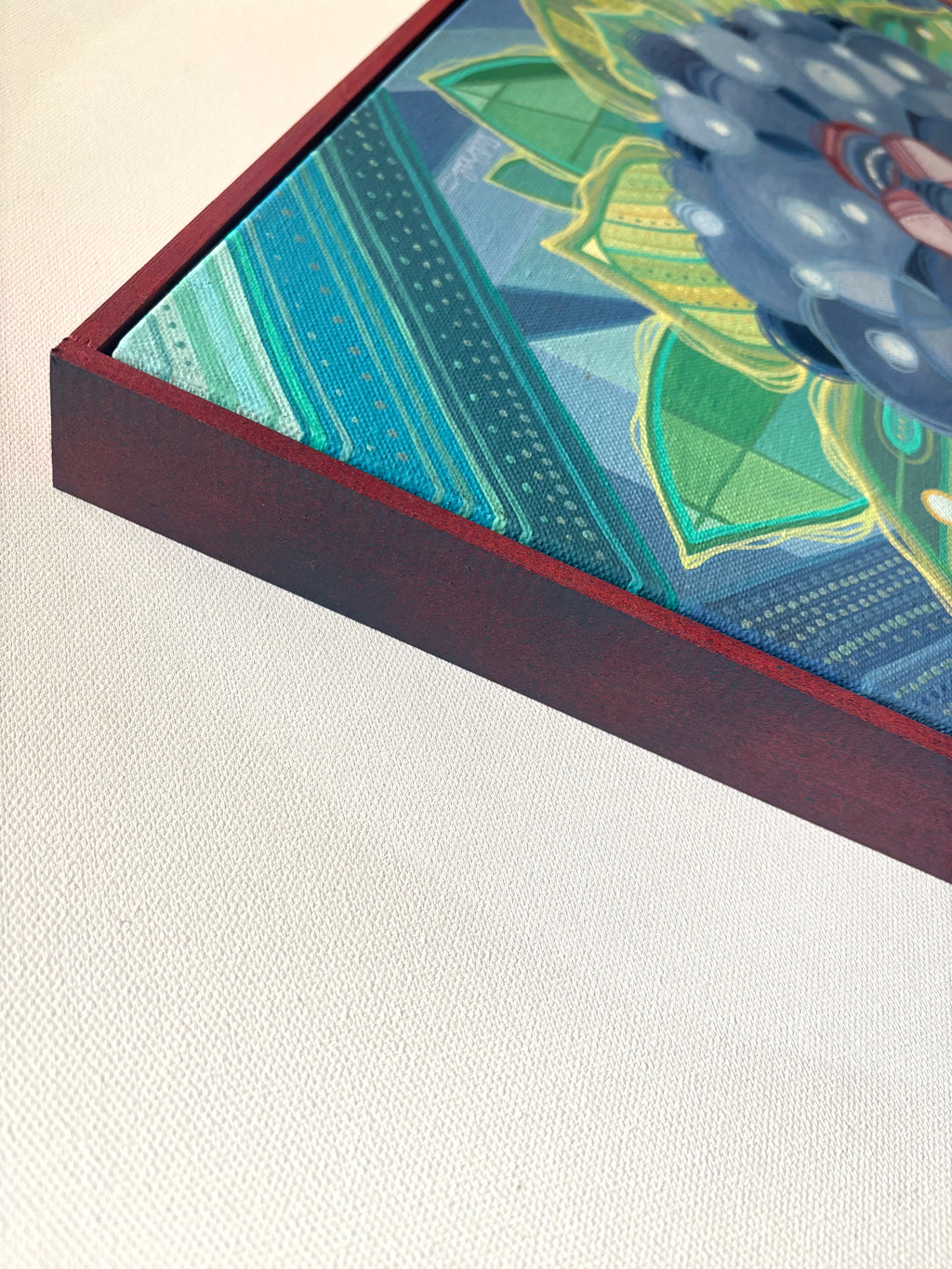 Close-up of a framed piece of art with a colorful abstract design on a light background