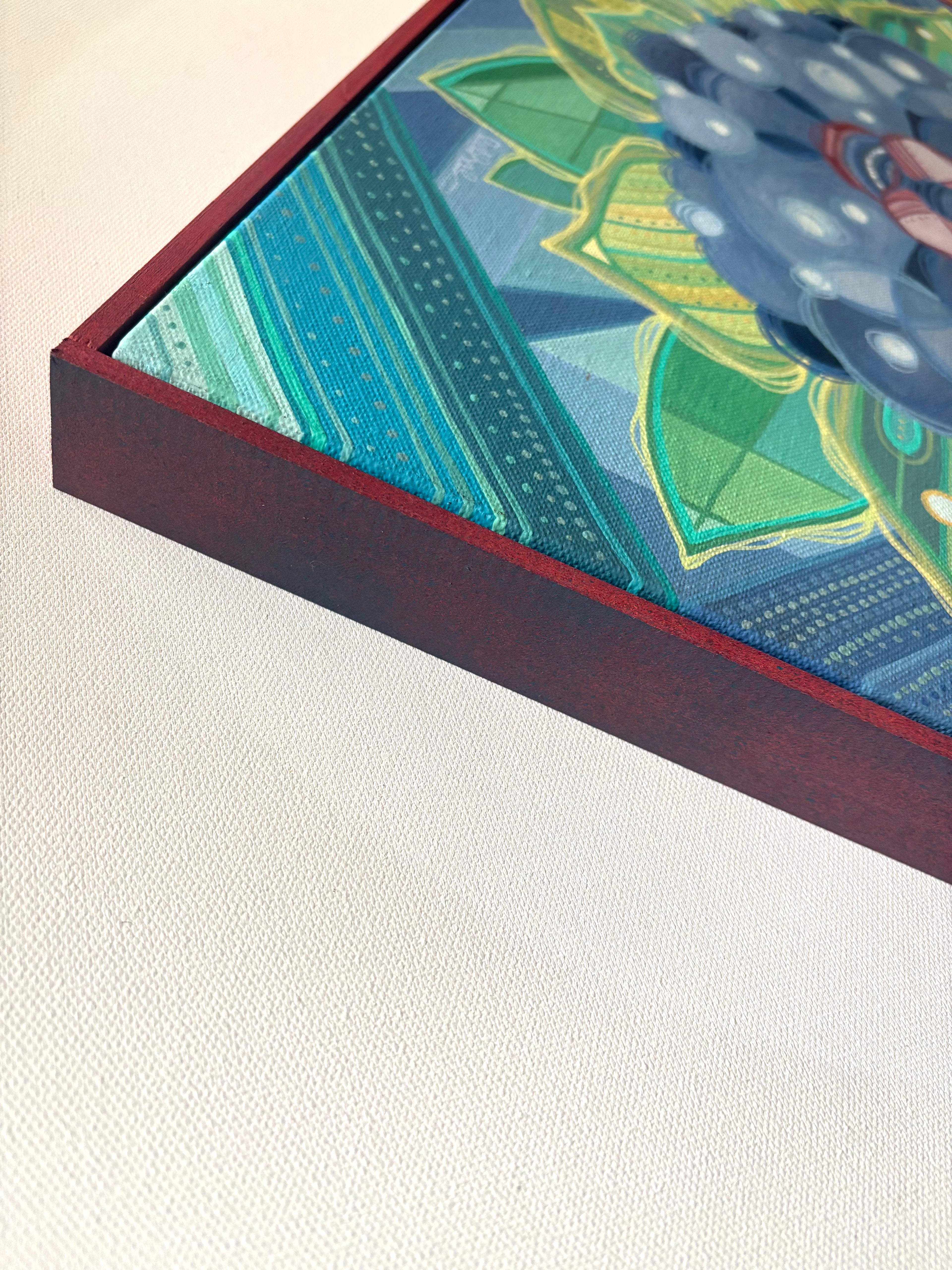 Close-up of a framed piece of art with a colorful abstract design on a light background