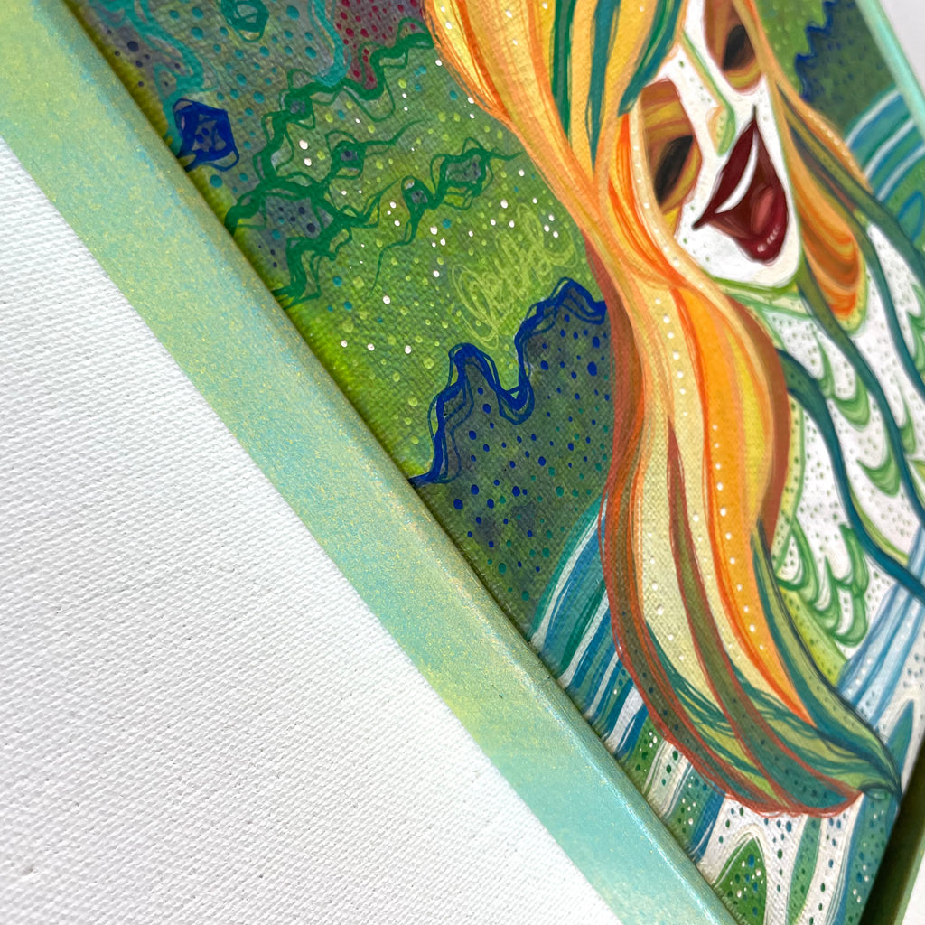 Colorful abstract painting with a feminine energy laughing face and flowing hair on a textured white background.