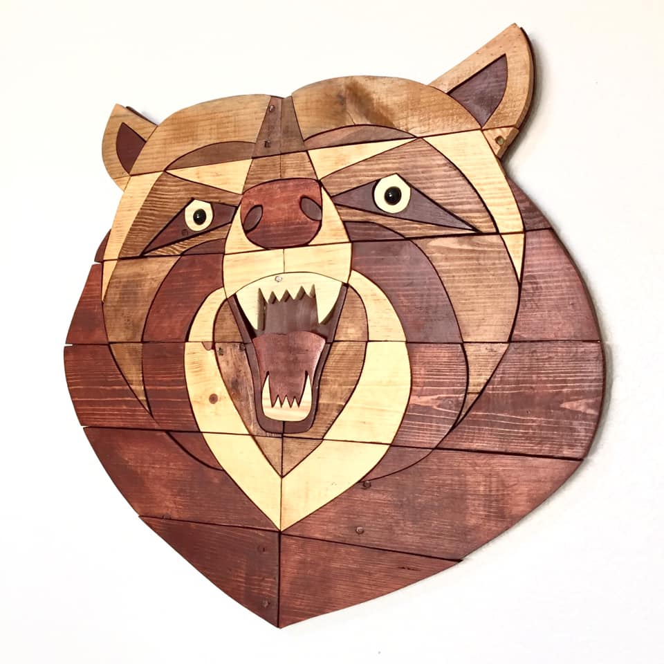Wooden puzzle in the shape of a bear's head on a white background