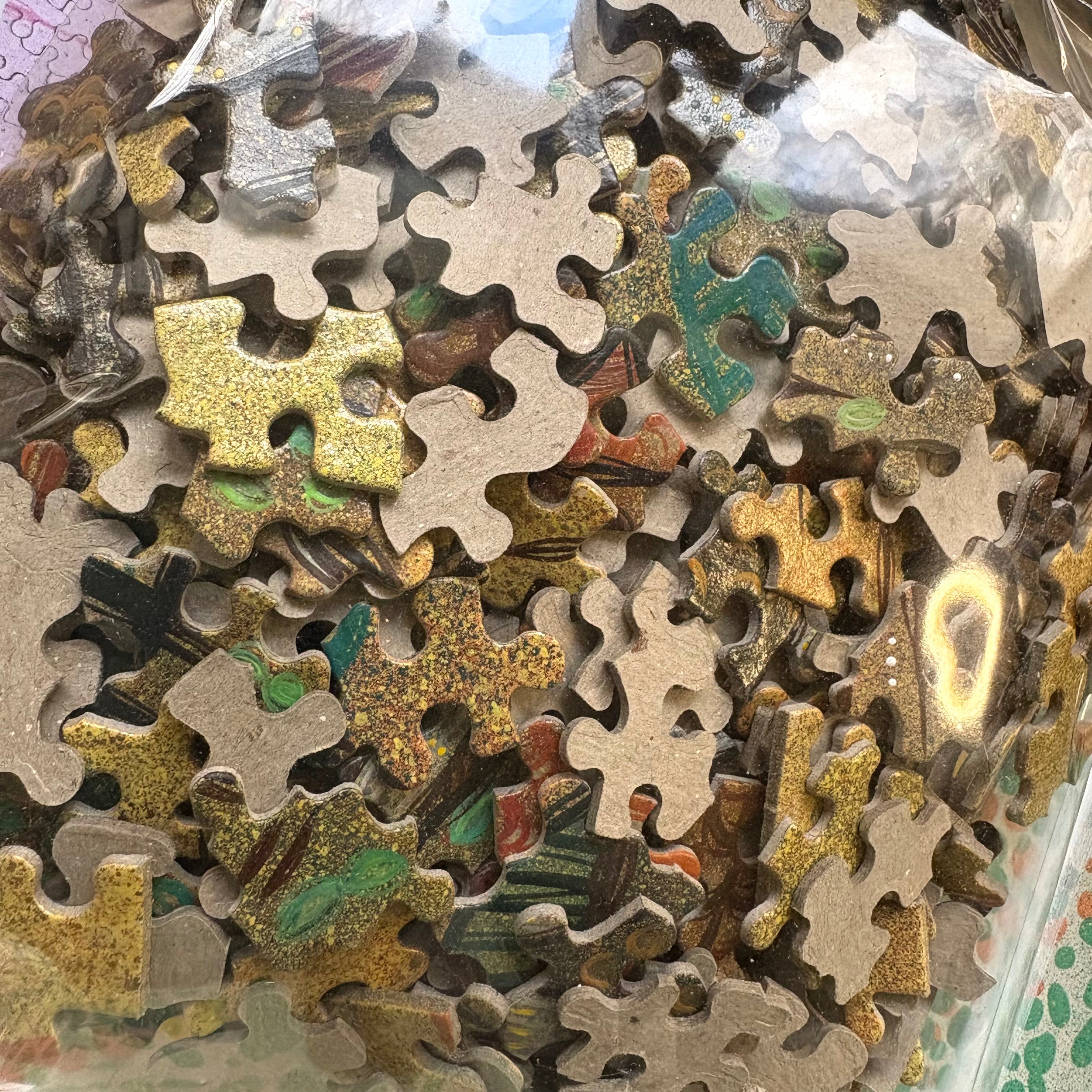Close-up of assorted puzzle pieces with different shapes and colors hand painted 