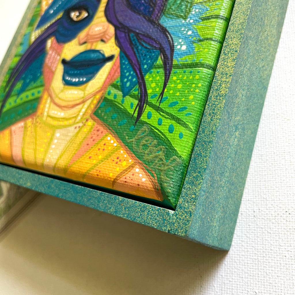 Colorful painting of a stylized face with blue hair and green background, framed in teal.