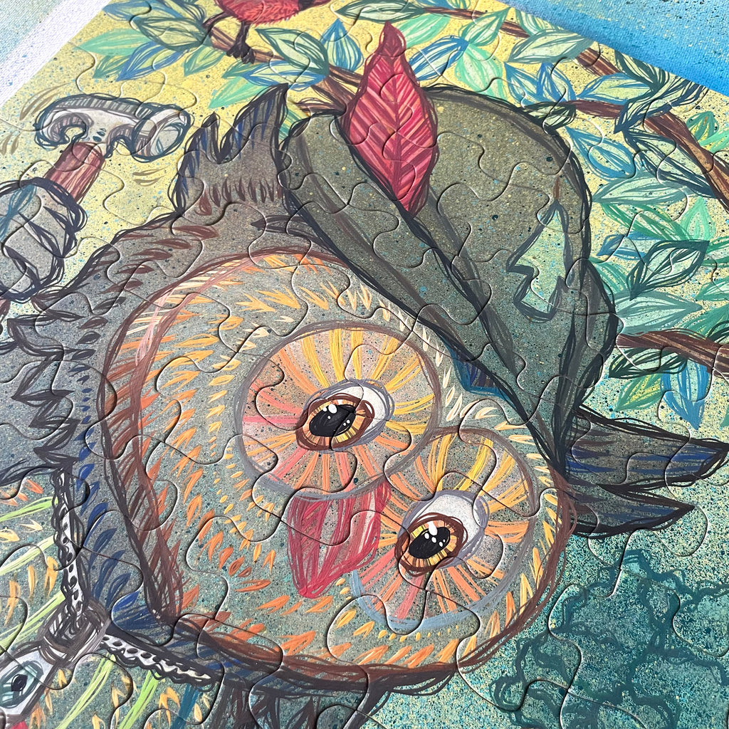 Close-up of a puzzle with a painted owl design on a colorful background